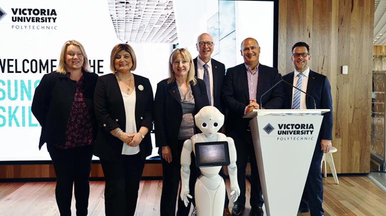 VU staff with robot at Sunshine Skills Hub opening