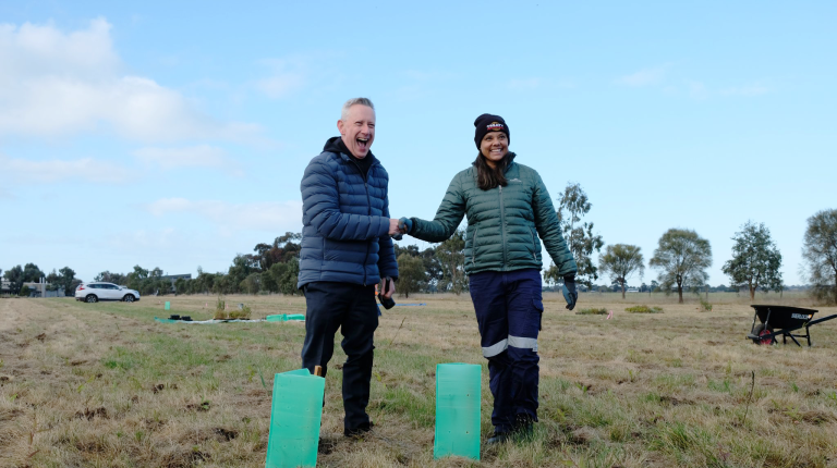  Vice Chancellor Professor Adam Shoemaker and VU Student Tahnee Towers plant the first tree.