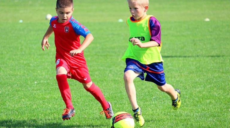 Two boys playing football