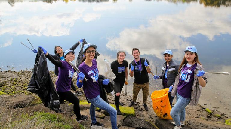 V4U volunteers pick up rubbish at the Maribyrnong River, near VU's Footscray Park Campus.