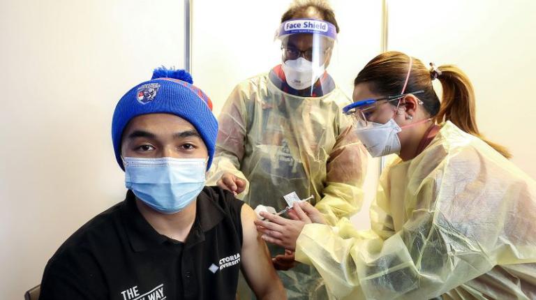 Rahmatullah Hossaini gets vaccinated at Whitten Oval's first pop-up clinic. Photo courtesy of Herald-Sun.
