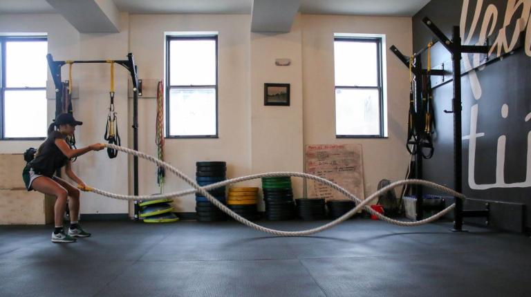 Woman working out with ropes