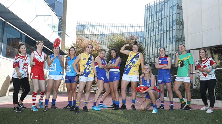 Megan Murphy, Anna Turner, Katarina Rebuffo, Courtney Ierano, Maddy Fenech, Ellyse Gamble, Jessie Davies, Caitlin Greiser and Alicia Root celebrate the new Victoria University partnership