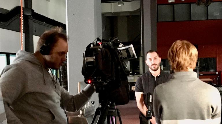 Dr Yanni Bouras being interviewed by the ABC at Footscray Park
