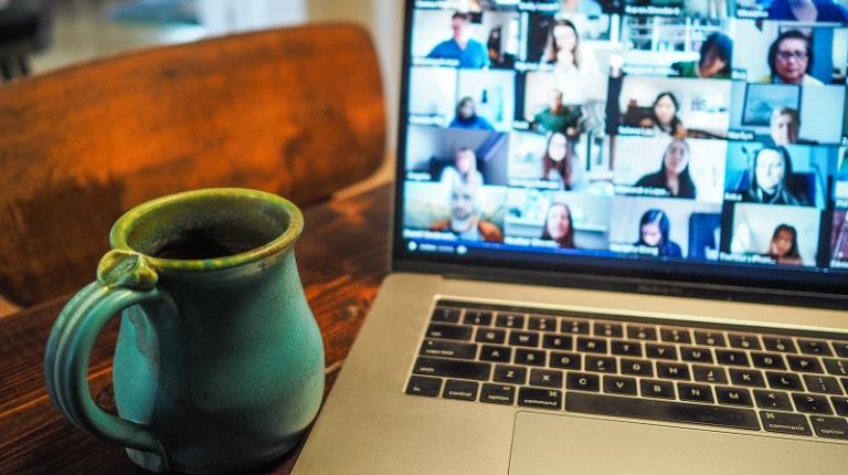 computer on desk showing Zoom meeting