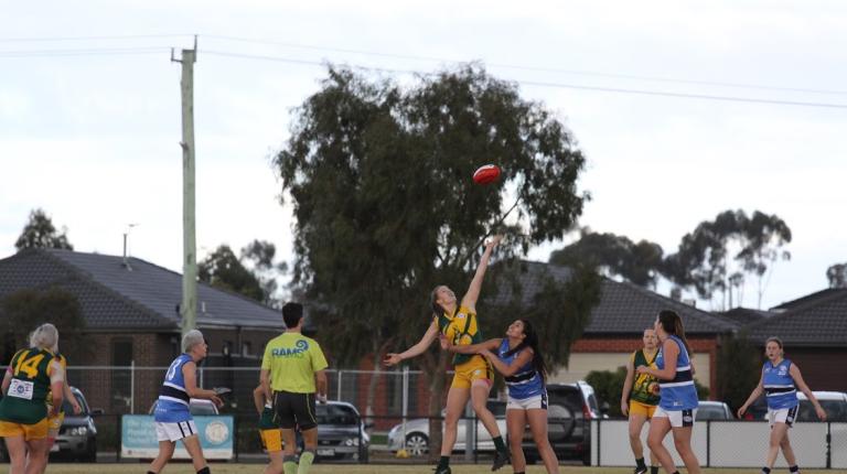 Female AFL players, mid-game