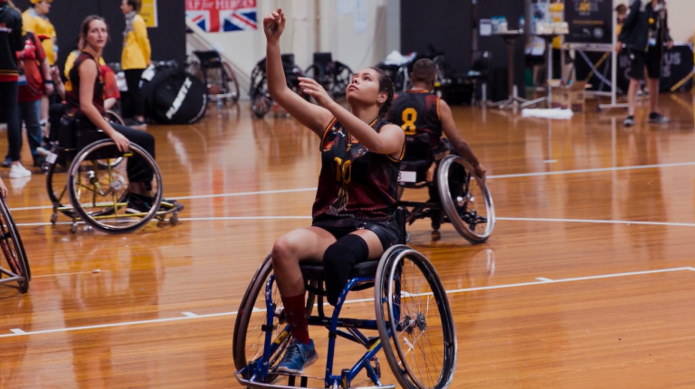indigenous female athlete playing wheelchair basketball