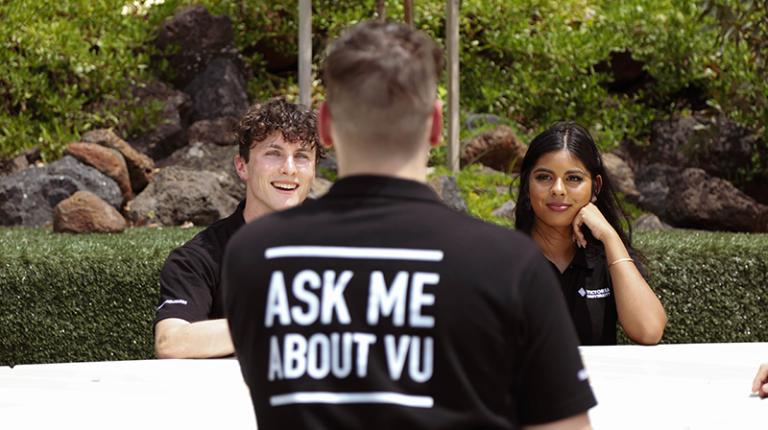 3 student ambassadors - one with a T-Shirt reading 'Ask me about VU'