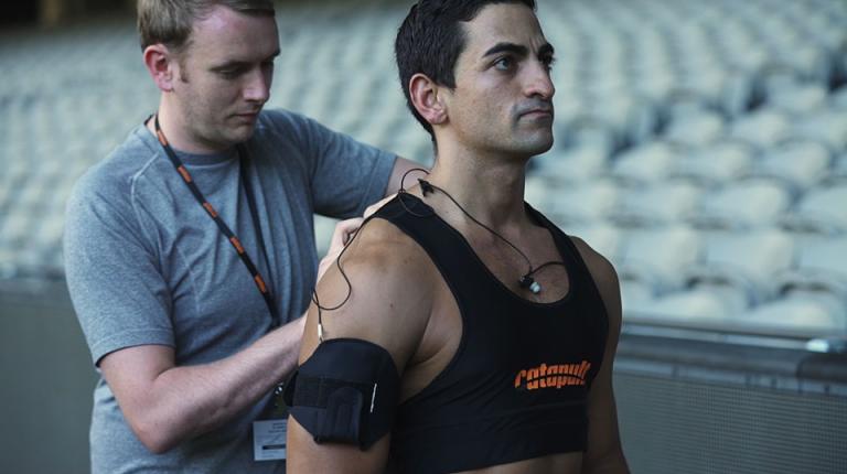  A man is fitted out with electronic tracking devices.