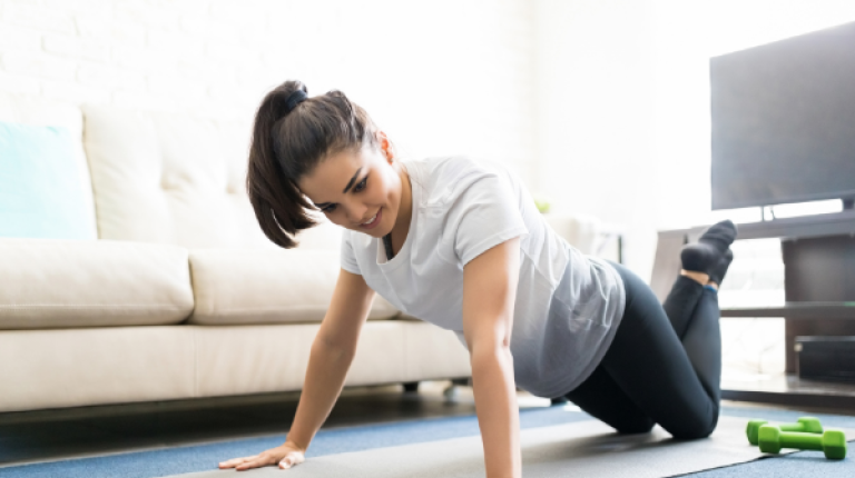  woman exercising on the floor of her lounge room