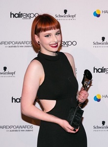 Jessie McAllister holding her hairdressing award