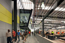 Students walking between the classroom and workshop space